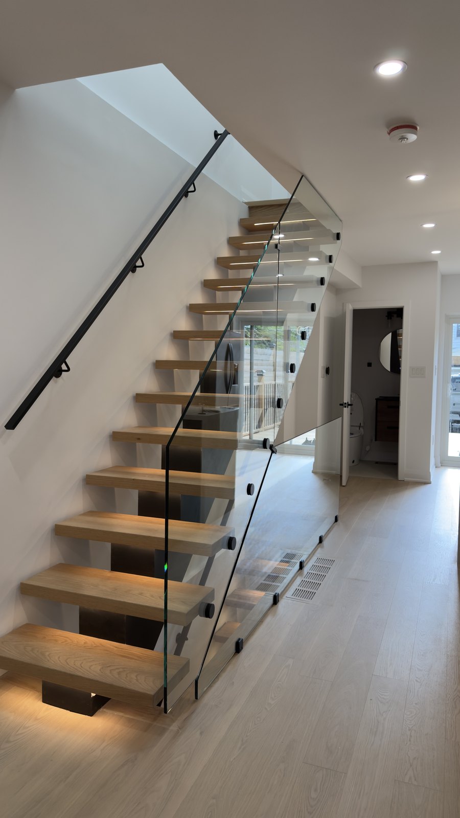 Glass-Rail Floating Staircase by Barewalls Construction