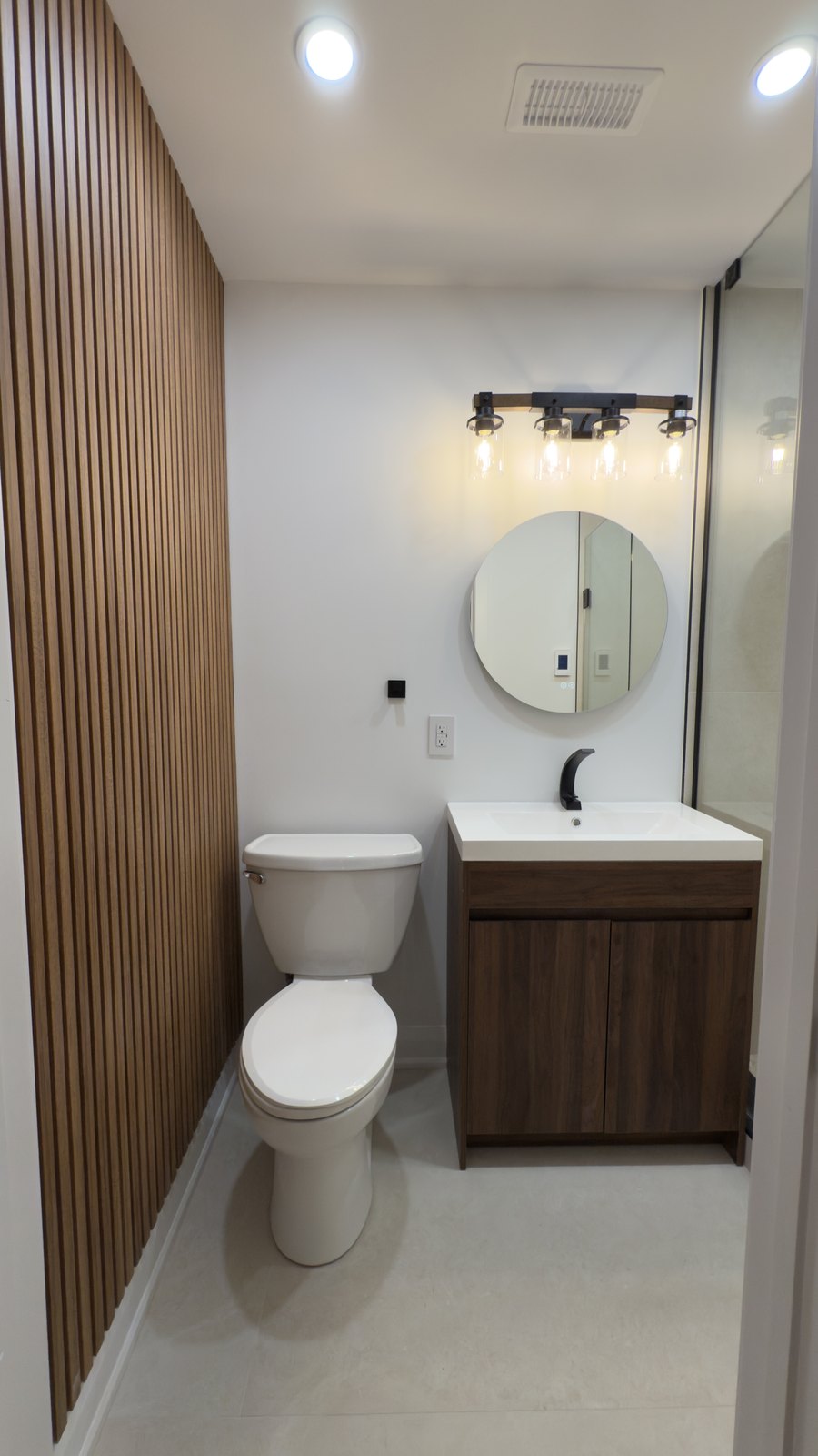 Wood-Slat Powder Room by Barewalls Construction