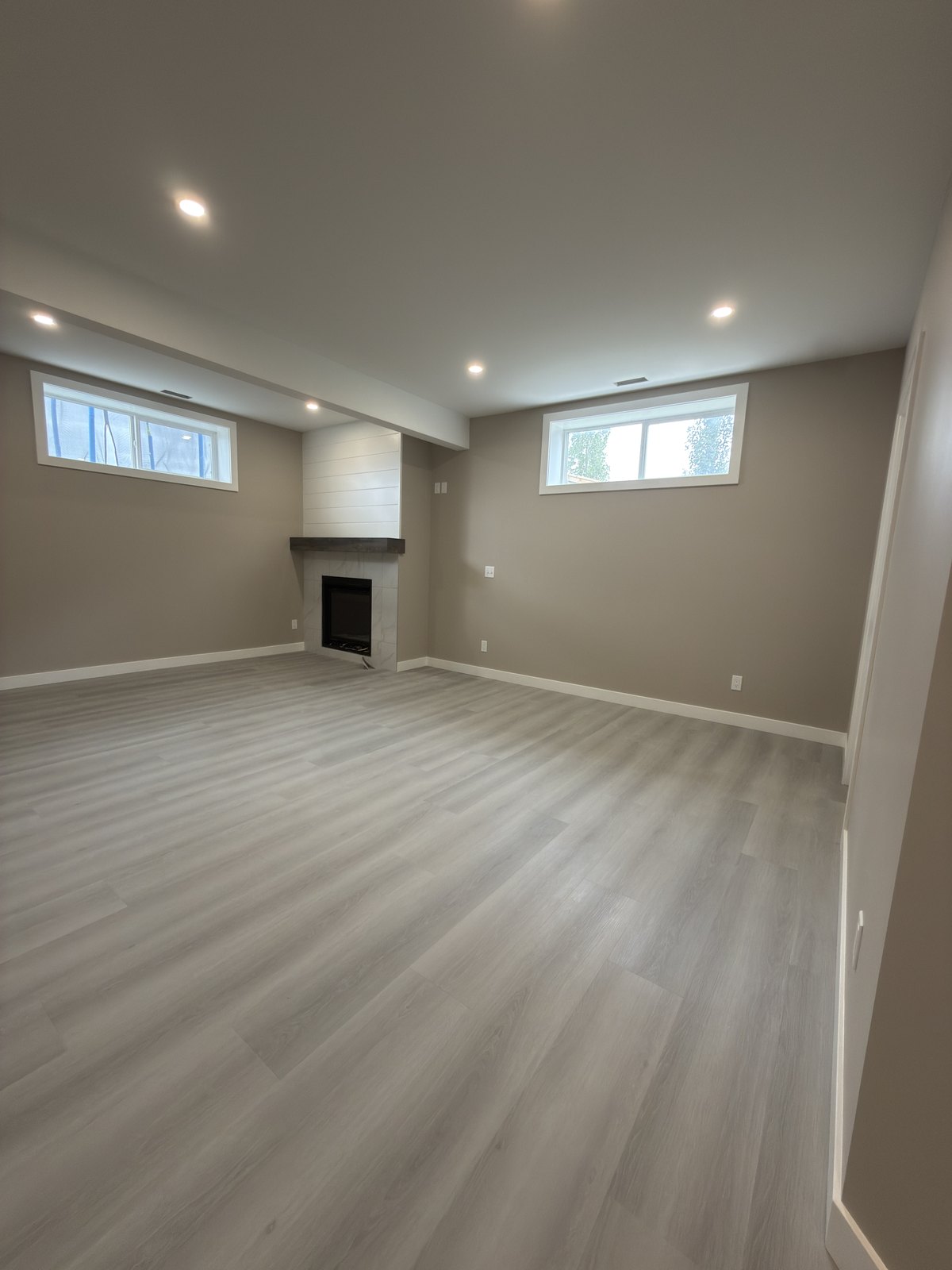 Finished Basement Living Room by Barewalls Construction