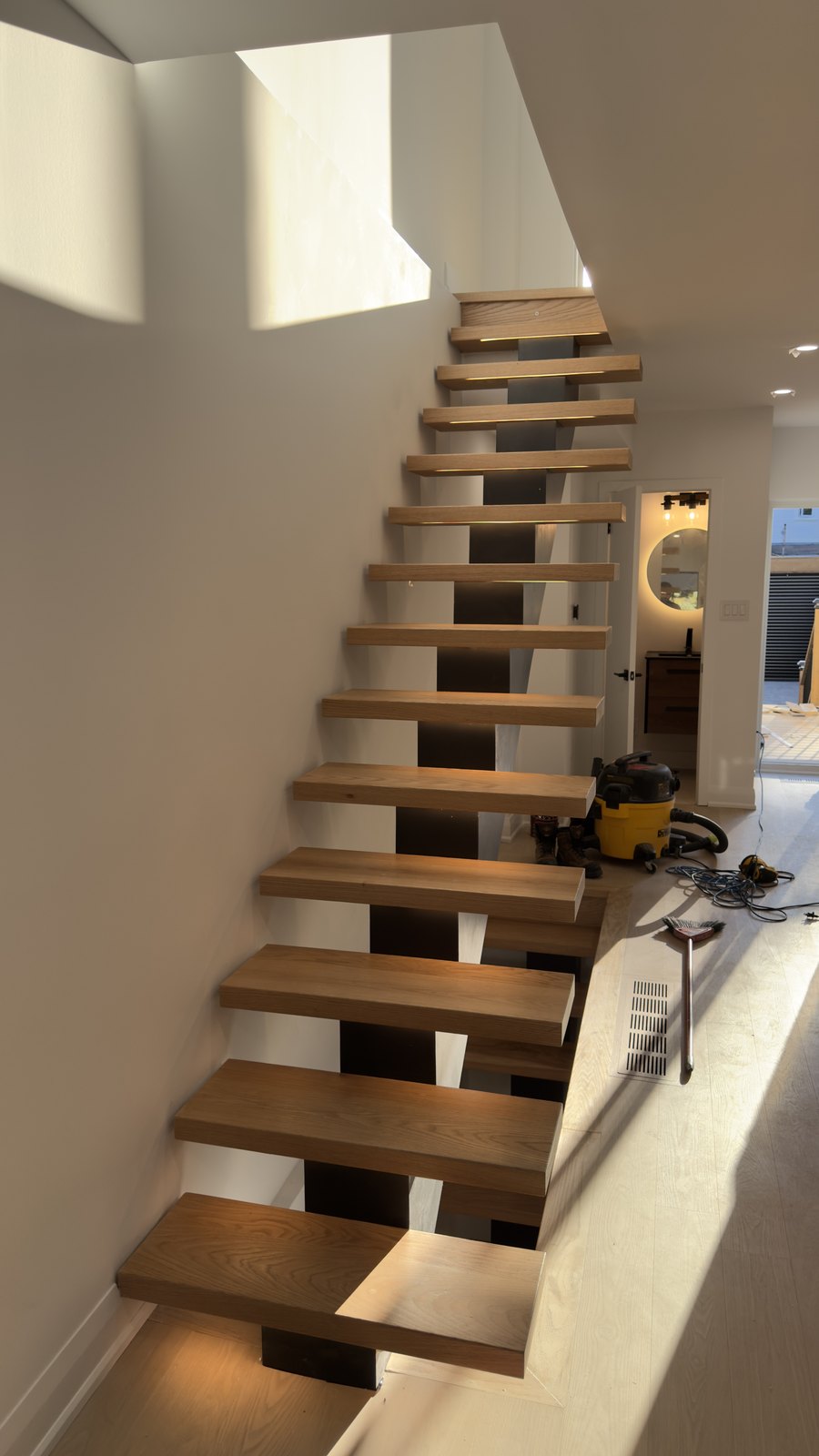 Custom Open-Riser Staircase by Barewalls Construction